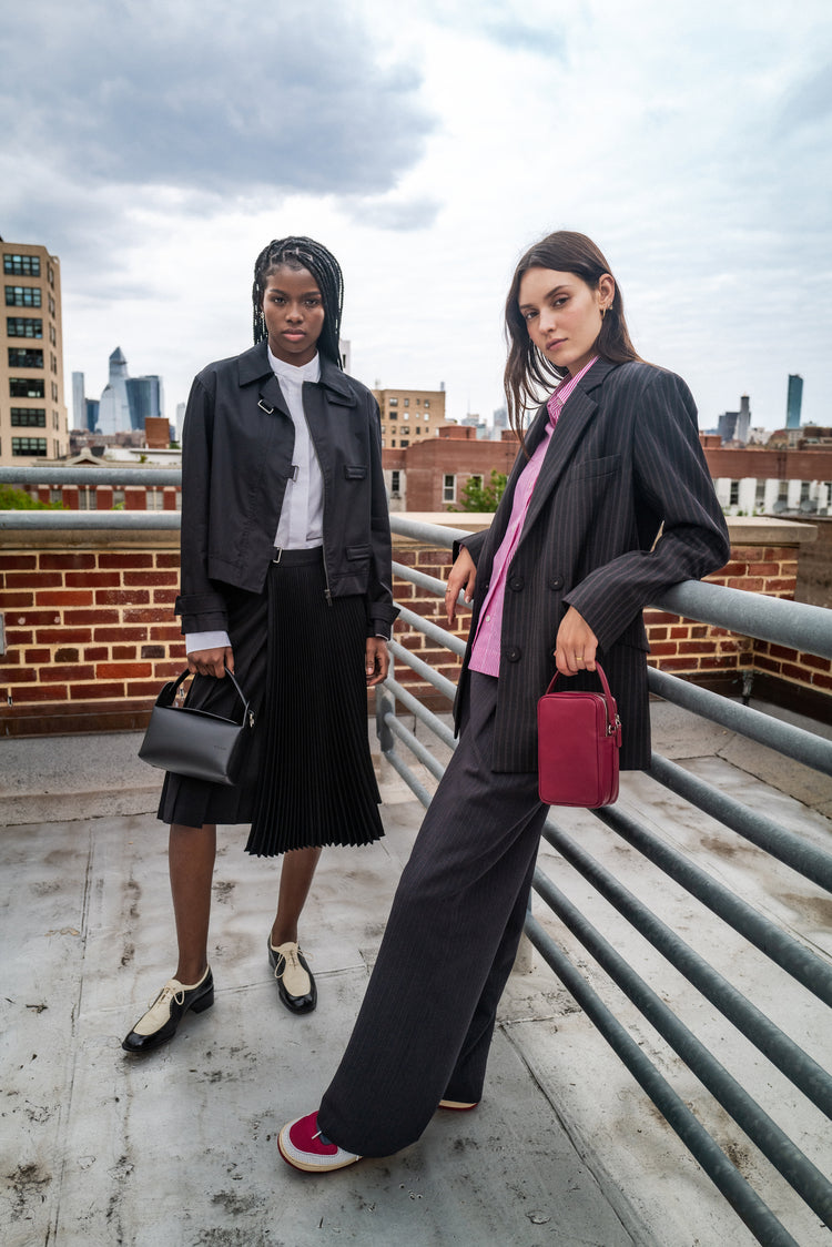 Two WE-AR4 models standing on rooftop in NYC wearing clothing from Capsule 007: Fire